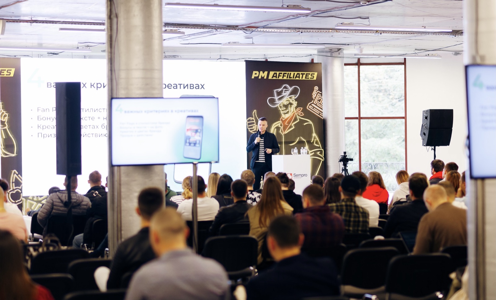 Evgeniy presenting to an audience at an industry event