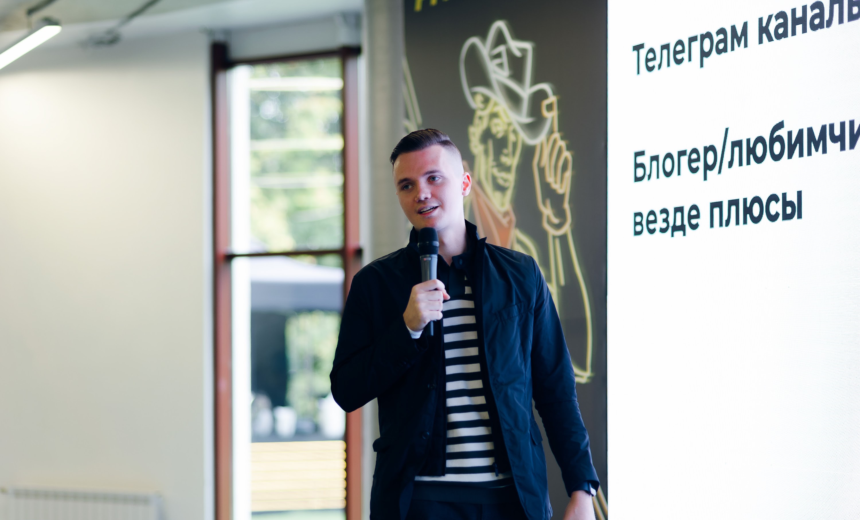Evgeniy speaking into a microphone during a presentation